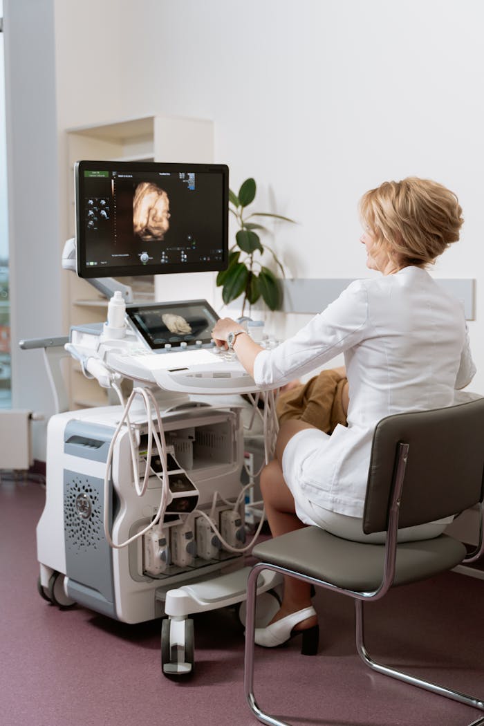 Healthcare professional conducting an ultrasound in a clinic.